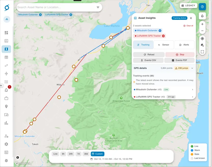 OnSight map near Lake Waihola showing the Mitsubishi Outlander track in blue and the LoRaWAN GPS Tracker track in red, with both assets selected in the tracking events panel.